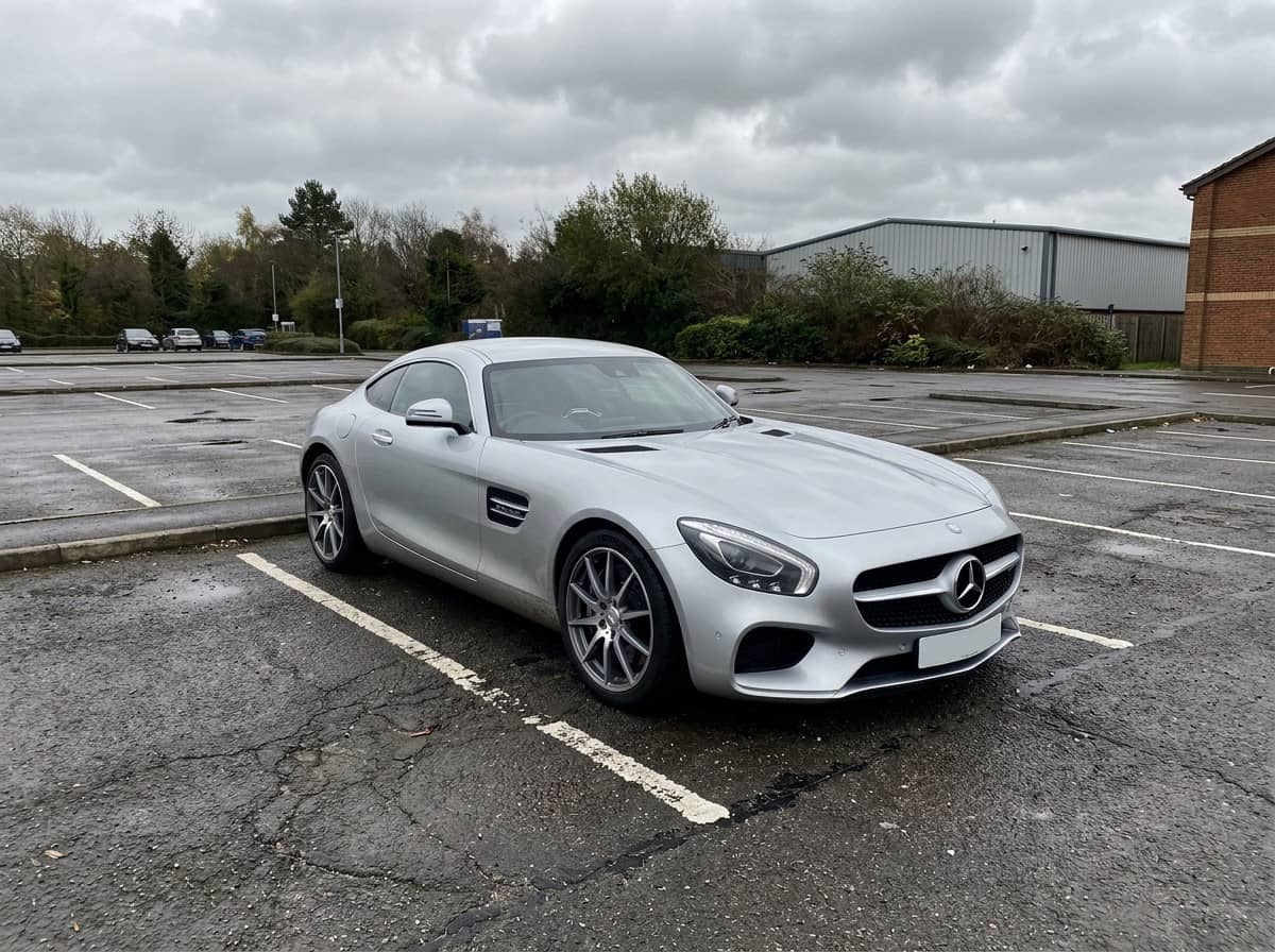 Phone photo of a stock silver sports coupe parked in a lot